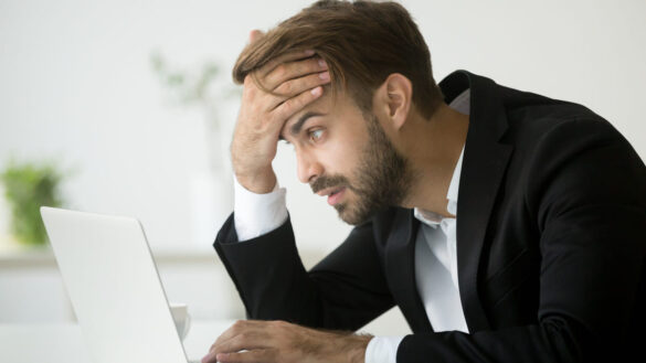 Anxious man at laptop