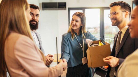 Day one rights in the Employment Rights Bill - webinar. Photo shows a woman being greeted by new colleagues on her first day.
