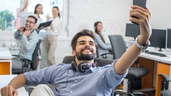 Noisy age discrimination harassment. Photo shows young people in a boisterous office.