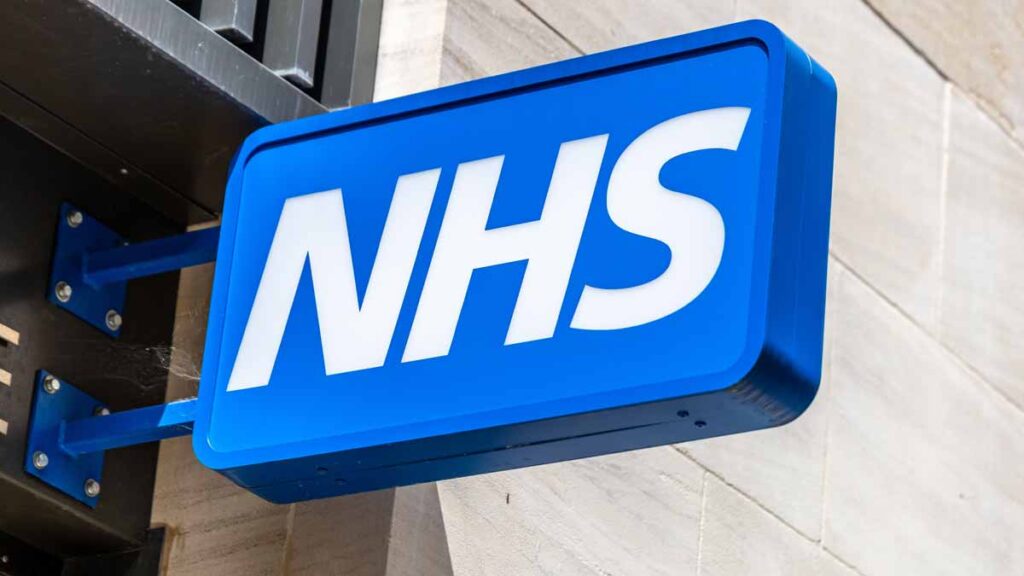 Nurse and midwife graduate guarantee. Photo shows an NHS sign.