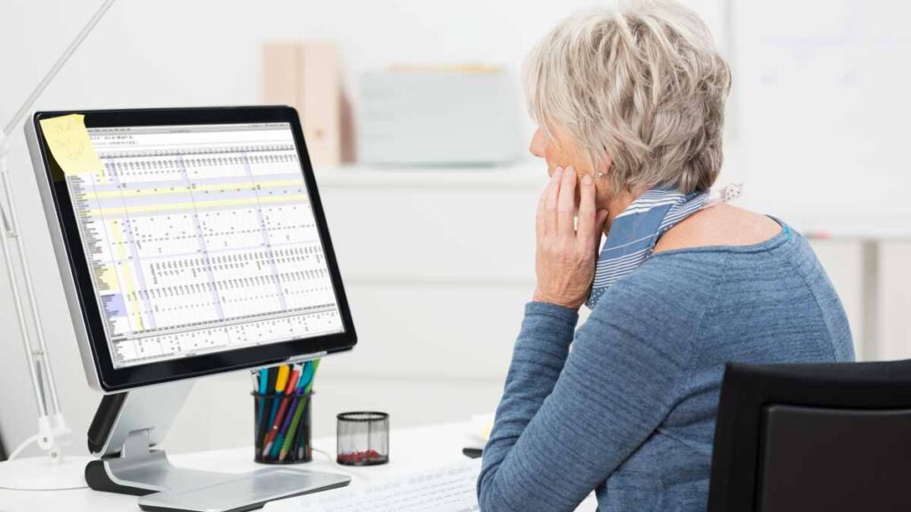 Over-50s employment: Photo shows older woman working at a computer.