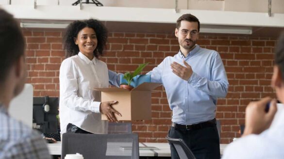 Day one rights caution: Photo shows woman being welcomed by a team on her first day at work.