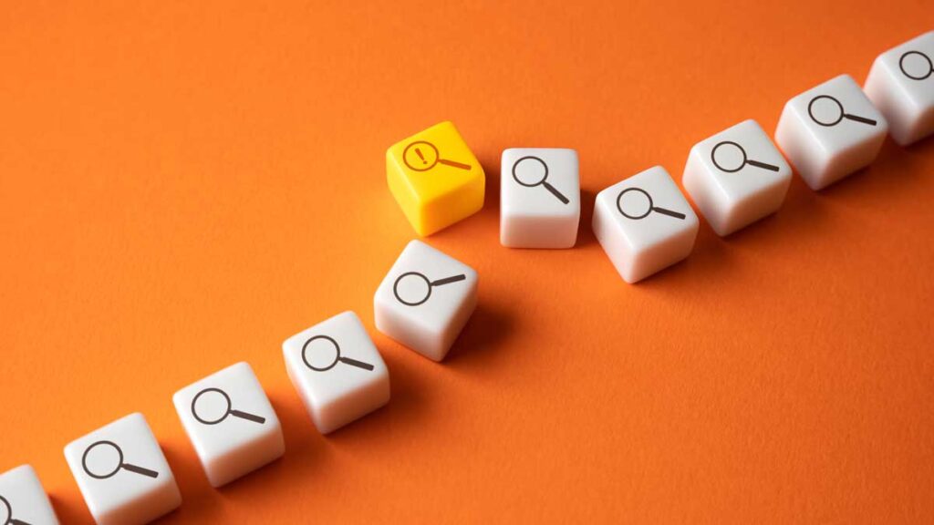 Failure to prevent fraud training. Image show numerous dice with magnifying glass symbols, with one carrying a warning sign.