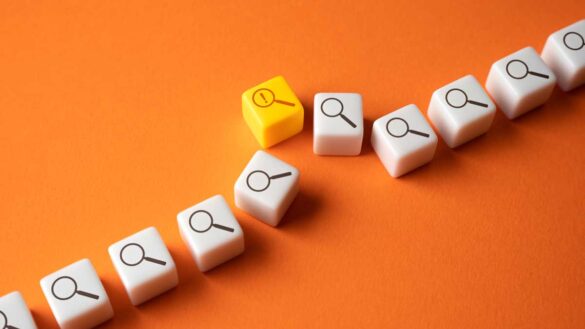 Failure to prevent fraud training. Image show numerous dice with magnifying glass symbols, with one carrying a warning sign.